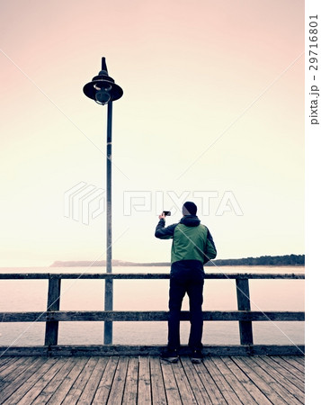 Man stay bellow old lamp.  Depression evening 29716801