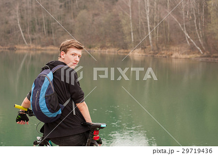 Young man on mountain bike relaxes 29719436