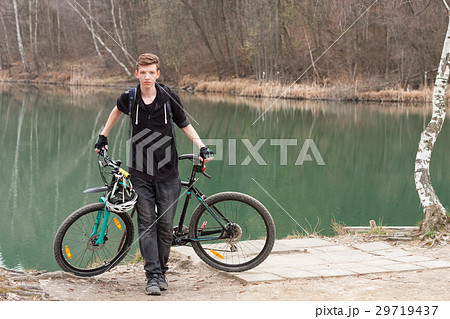 Young man on mountain bike relaxes 29719437