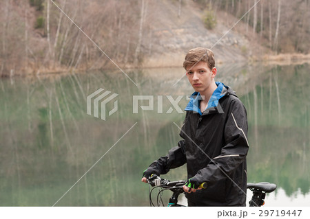 Young man on mountain bike relaxes 29719447
