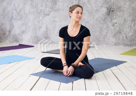 Young attractive woman practicing yoga, sitting in 29719848