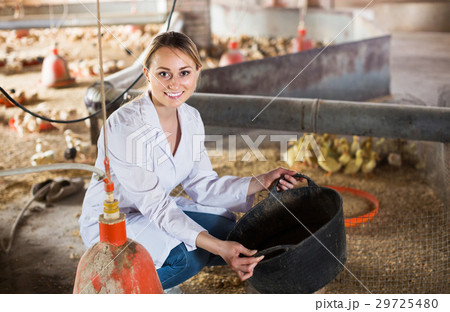 Female worker holding plastic bucket Female worker holding plastic bucket 29725480