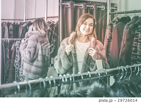 woman trying on fur coat in women’s cloths store woman trying on fur coat in women’s cloths store 29726014