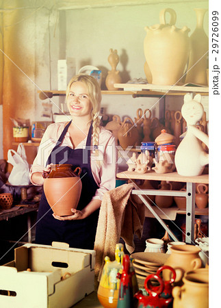 Young woman carrying ceramic vessels Young woman carrying ceramic vessels 29726099