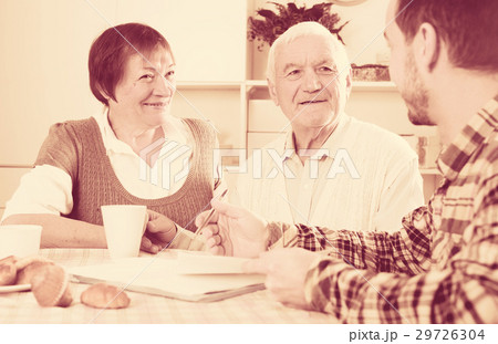 Aged couple signing agreement Aged couple signing agreement 29726304