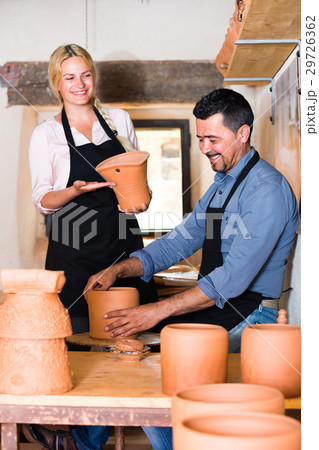 two potters working with ceramics in atelier. 29726362