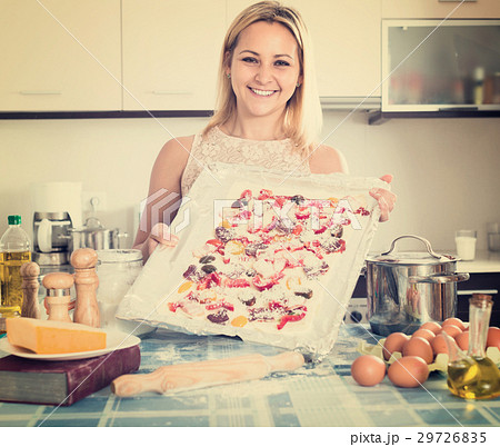 Smiling woman posing with pizza 29726835