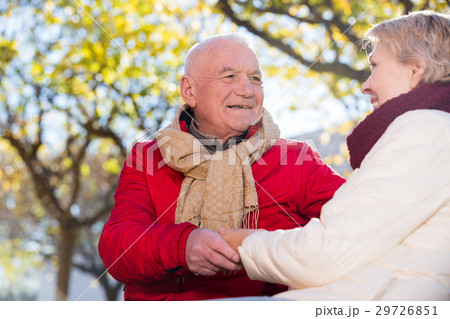 Mature couple talking in park Mature couple talking in park 29726851