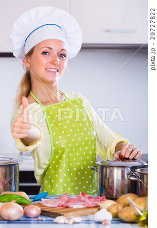 Cheerful housewife at kitchen. Cheerful housewife at kitchen. 29727822