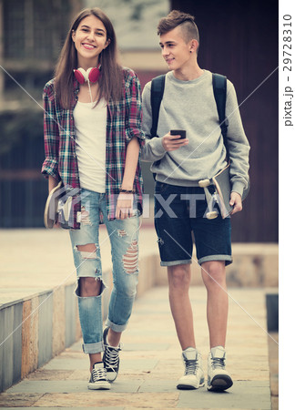 Teenagers with skateboards outdoors . 29728310