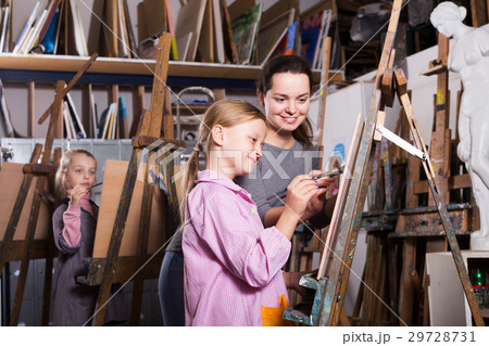 Teacher helping teenage students Teacher helping teenage students 29728731