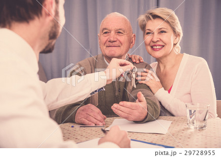 Old man and woman sign rent agreement Old man and woman sign rent agreement 29728955