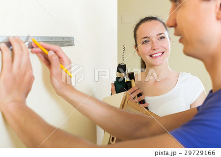 Couple makes repairs at home Couple makes repairs at home 29729166