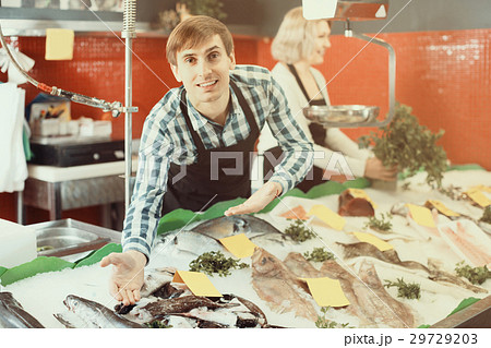 Sellers working in fish store 29729203