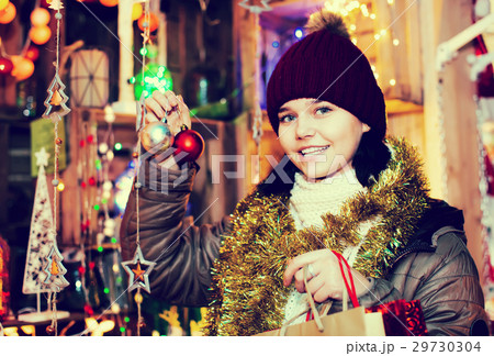 Girl choosing gifts at festive fair before Christmas Girl choosing gifts at festive fair before Christmas 29730304