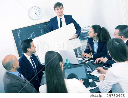 Businessman presents new development plan at poster 29730498