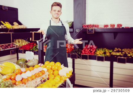Young man seller displaying assortment 29730509