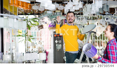 Couple choosing round ceiling lamp 29730544