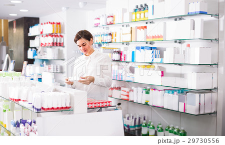 Woman is browsing rows of body care products Woman is browsing rows of body care products 29730556