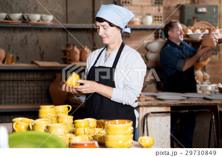 Elderly potters among their products 29730849