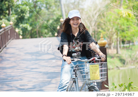 young asian woman/traveller with riding road bike young asian woman/traveller with riding road bike 29734967