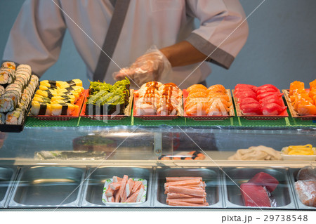 sashimi and nigiri on sushi bar with blurred chef 29738548