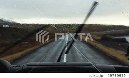 On the road in rainy day, car windshield 29739955