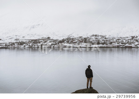 a man standing on rock with view of the Akereyri  29739956