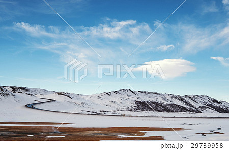 Landscaped in winter with country road  29739958