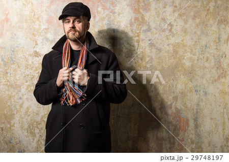 Serious bearded man wearing a cap and autumn coat 29748197