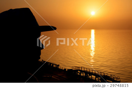 Silhouette man on sunset background Silhouette man on sunset background 29748815