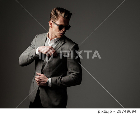 Confident sharp dressed man in grey jacket. Confident sharp dressed man in grey jacket. 29749694