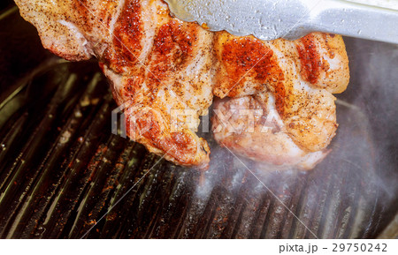 Hot Grilled beef steaks are cooking on grill  29750242