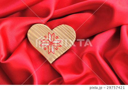 Wooden Heart on red satin background 29757421