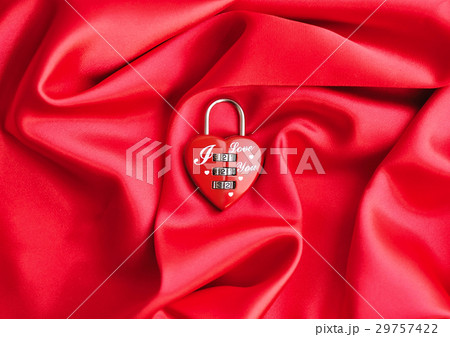 Padlock heart-shape on satin fabric background 29757422