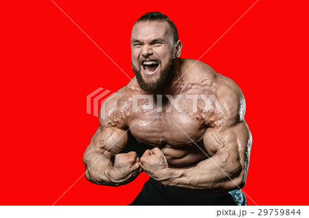 Handsome athletic man training pumping up muscles Handsome athletic man training pumping up muscles 29759844