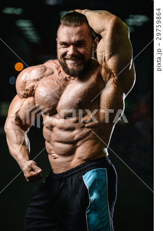 Handsome athletic man training pumping up muscles Handsome athletic man training pumping up muscles 29759864