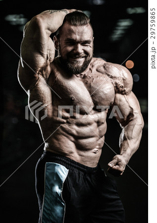 Handsome athletic man training pumping up muscles Handsome athletic man training pumping up muscles 29759865