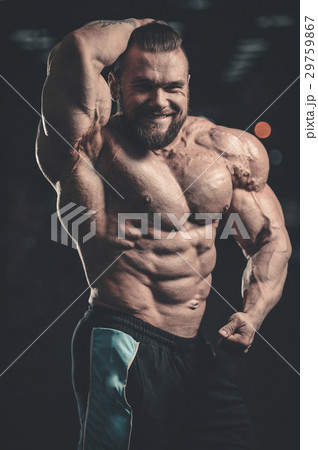 Handsome athletic man training pumping up muscles Handsome athletic man training pumping up muscles 29759867