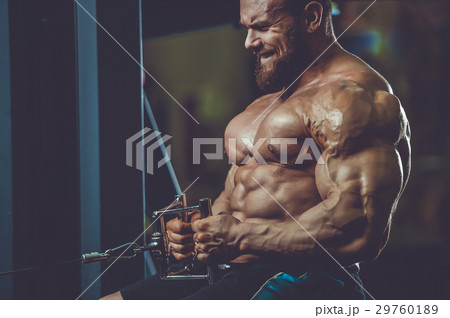 Handsome athletic man training pumping up muscles Handsome athletic man training pumping up muscles 29760189