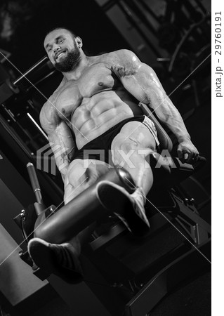 Handsome athletic man training pumping up muscles Handsome athletic man training pumping up muscles 29760191