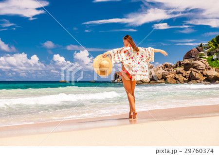 Woman with sarong on beach at Seychelles 29760374