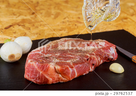 Raw meat steak on dark stone background roasting Raw meat steak on dark stone background roasting 29762537