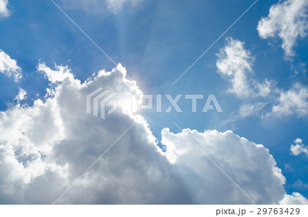 Sunbeam behind the white cloud and blue sky Sunbeam behind the white cloud and blue sky 29763429