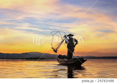 Silhouette fisherman on fishing boat setting net Silhouette fisherman on fishing boat setting net 29763486