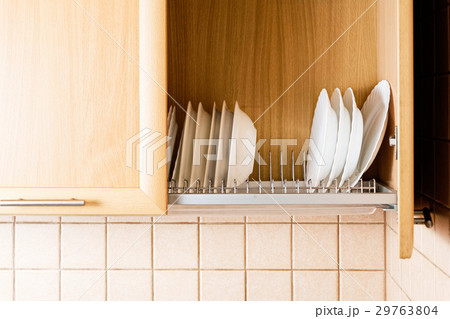 Dishes inside kitchen cupboard with open door Dishes inside kitchen cupboard with open door 29763804