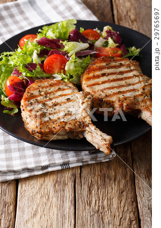 Grilled pork chop with fresh vegetable salad Grilled pork chop with fresh vegetable salad 29765697