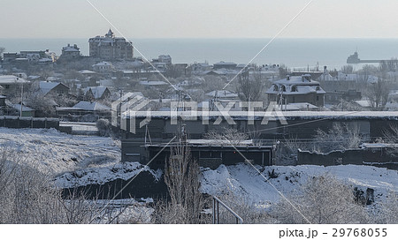 Snow-covered factory and city on a winter morning Snow-covered factory and city on a winter morning 29768055