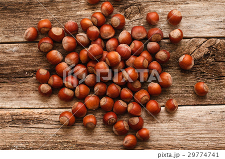 Heap of ripe hazelnuts on wood flat lay 29774741