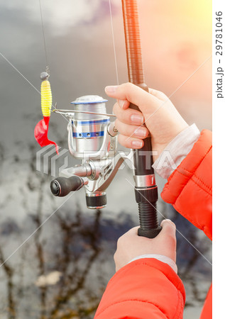 Female hands holding a fishing rod and lure. Female hands holding a fishing rod and lure. 29781046